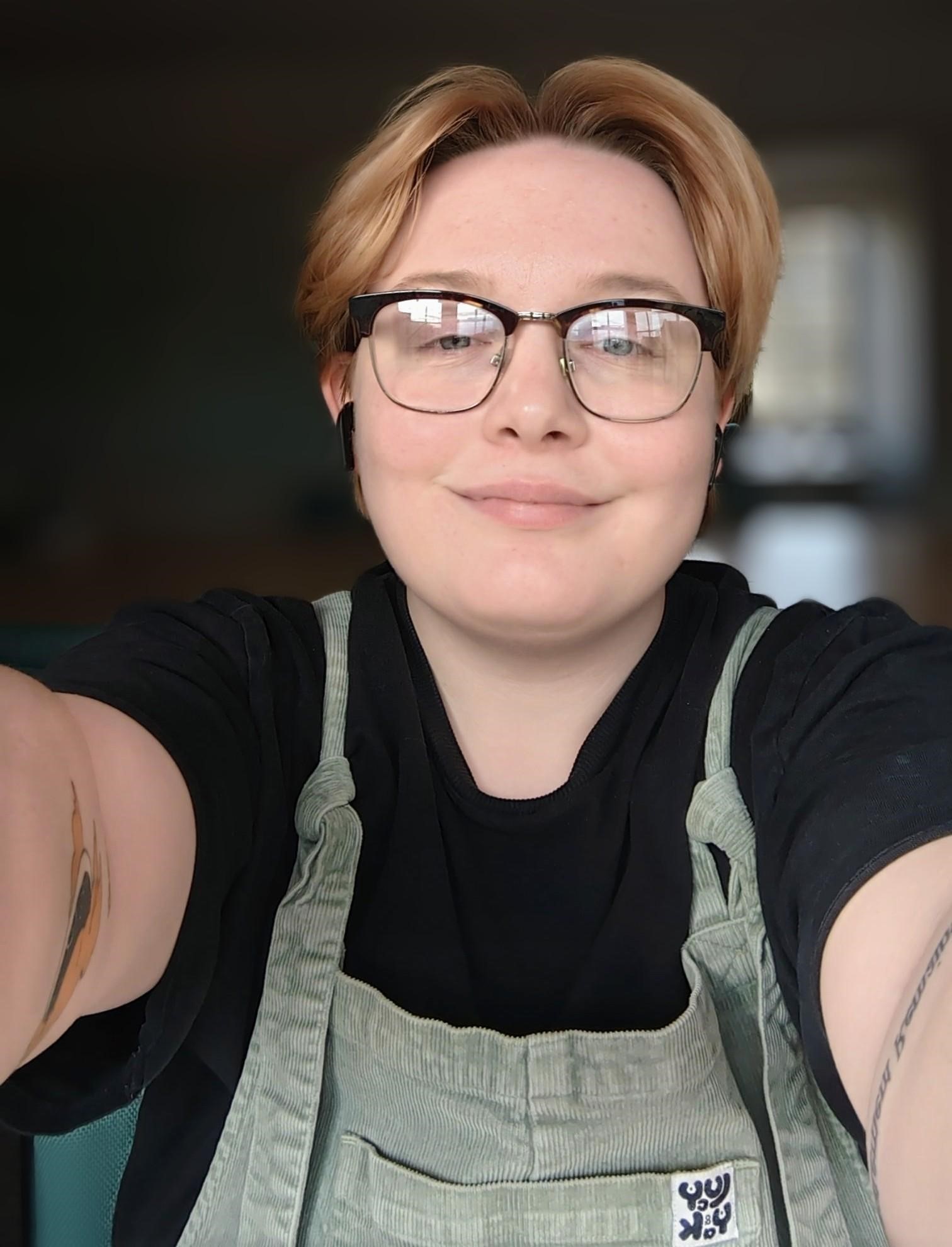 Image of non-binary intern smiling