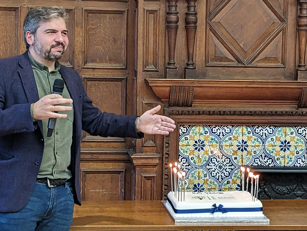 Spyros Kosmidis gives a speech in front of the Spring School birthday cake