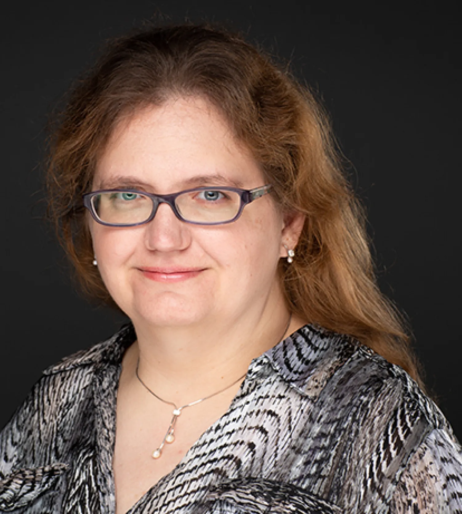 a person wearing glasses and a black and white shirt