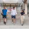 Four students walking down the stairs and talking in the Manor Road building