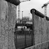 'Berlin loves you' sign visible through a gap in the Berlin wall.