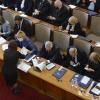 Overhead view of politicians sat in an assembly hall.