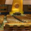 wide-angle photograph of United Nations Assembly Chamber, with hundreds of seats fanning out from stage 