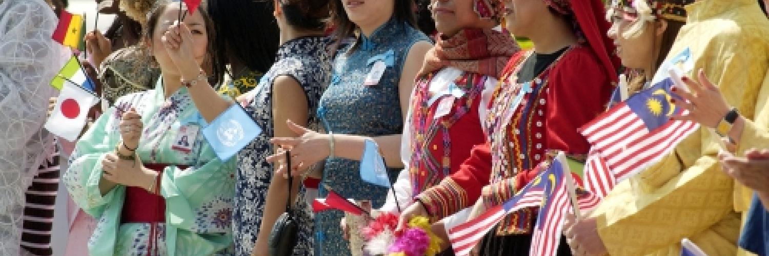 Image of a group of people dressed up holding flags at a parade.