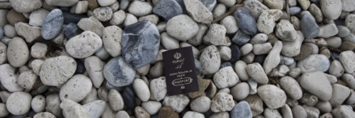 Image of a passport on some pebbles