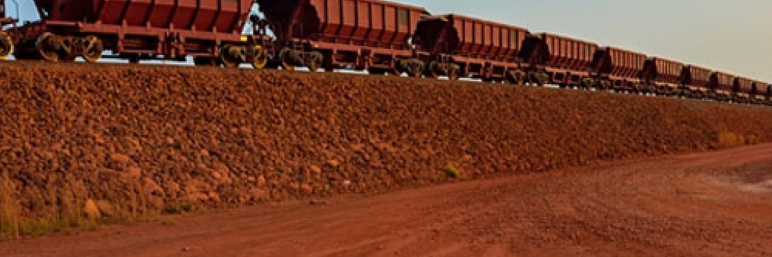 Train trucks passing through a harsh landscape