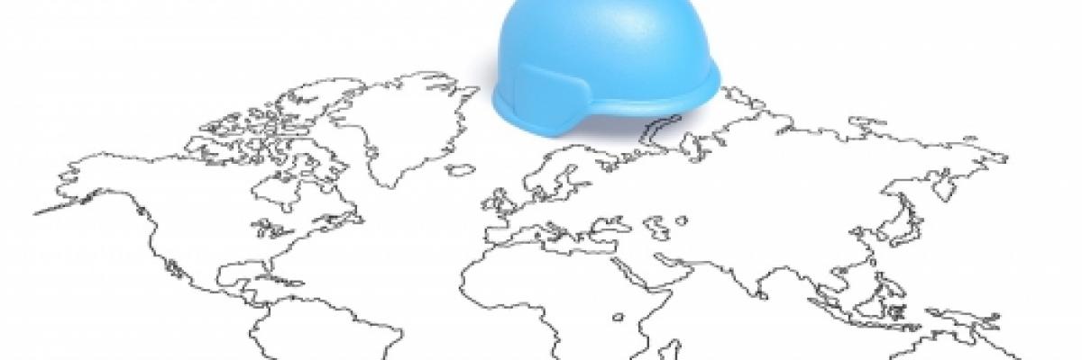 Image of a blue helmet over a map of the world