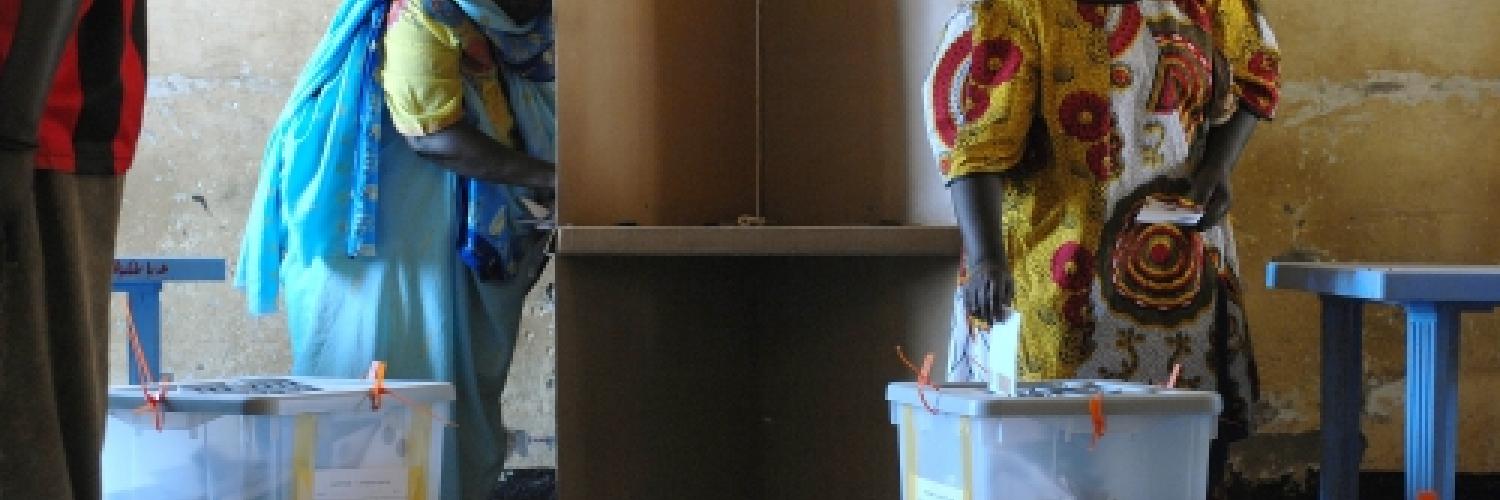 A photo of a woman in a voting booth and another posting her ballot paper in a ballot box.