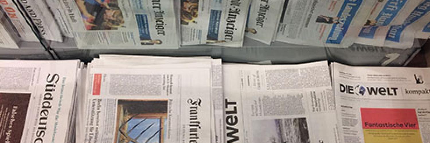 image of a selection of German newspapers in a newspaper stand