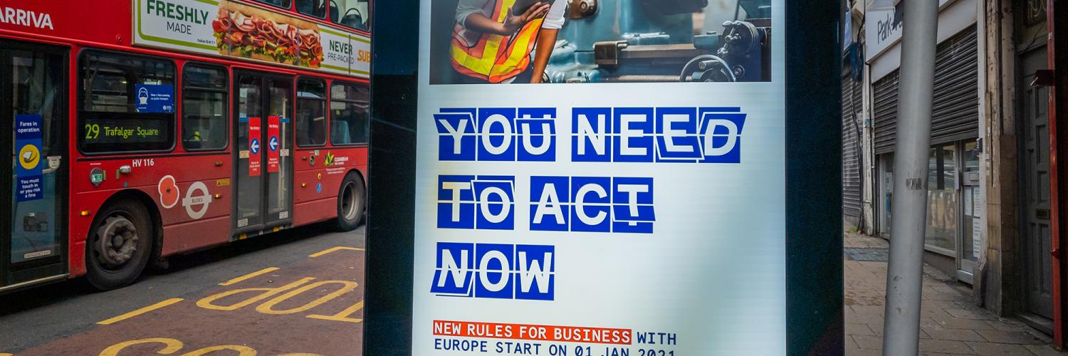 Image of a bus stop with a bus beside it