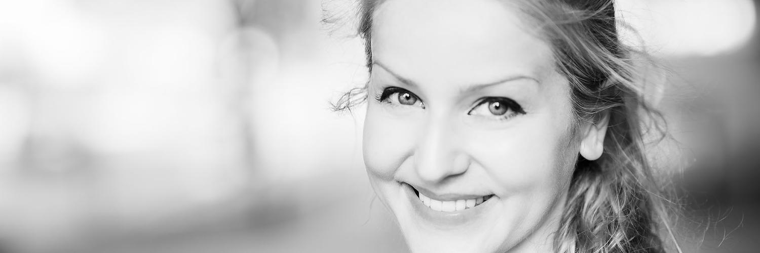 An image of a woman smiling at the camera