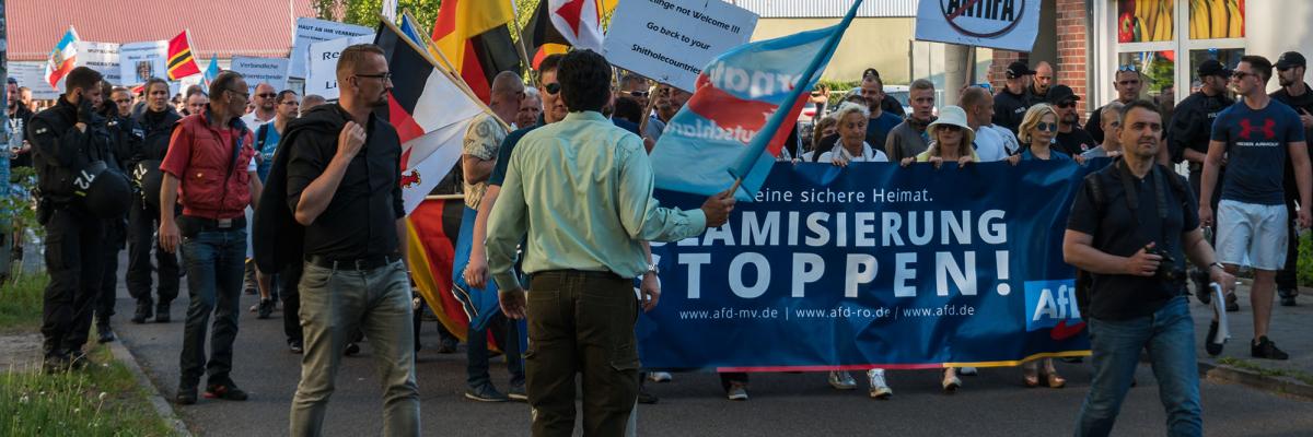 A group of people marching with a banner