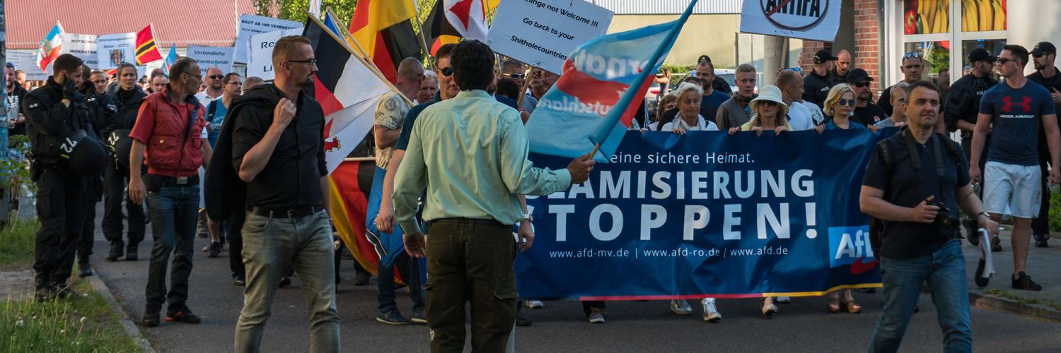 A group of people marching with a banner