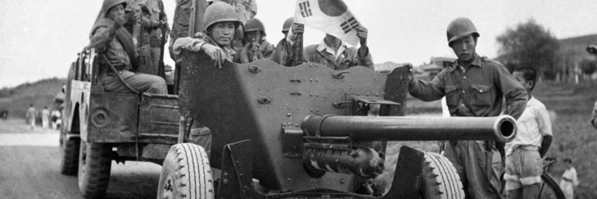 A group of soldiers standing in a military vehicle.