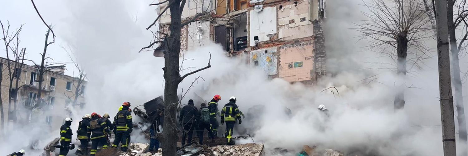a group of firefighters standing near a building