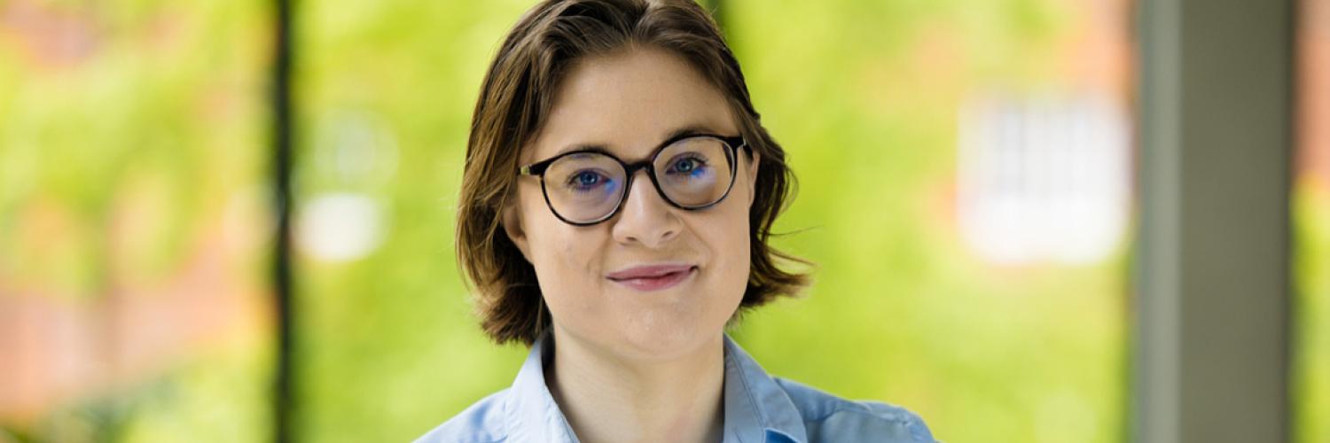 Image of a person wearing glasses and a blue shirt