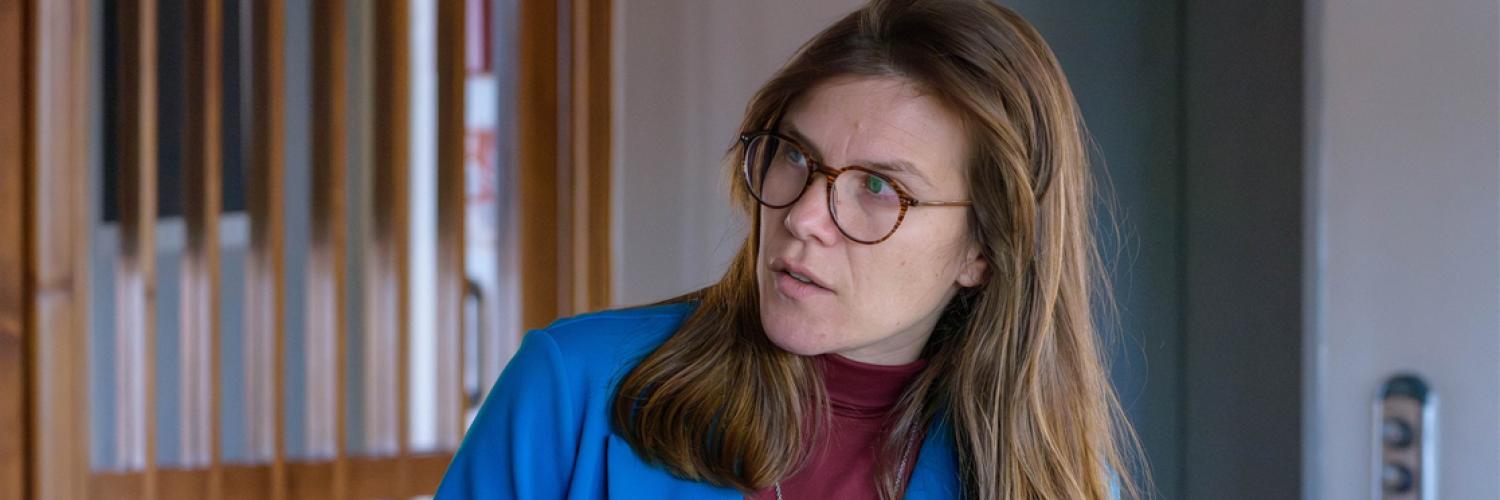 Image of a woman wearing glasses looking to her right