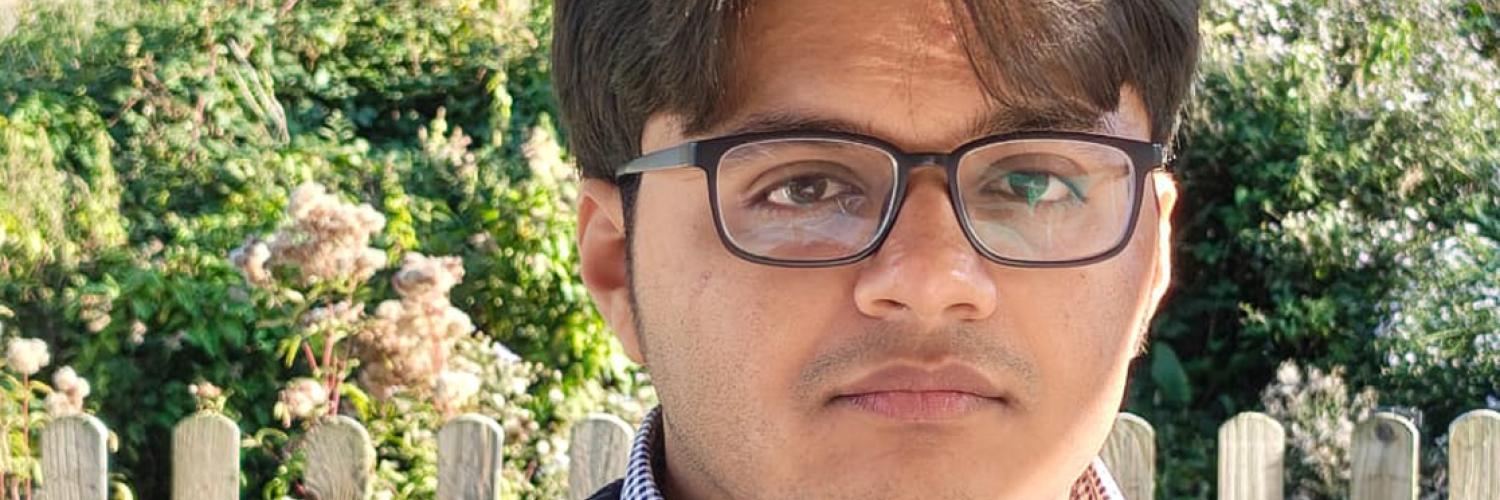 a person wearing glasses looking at the camera