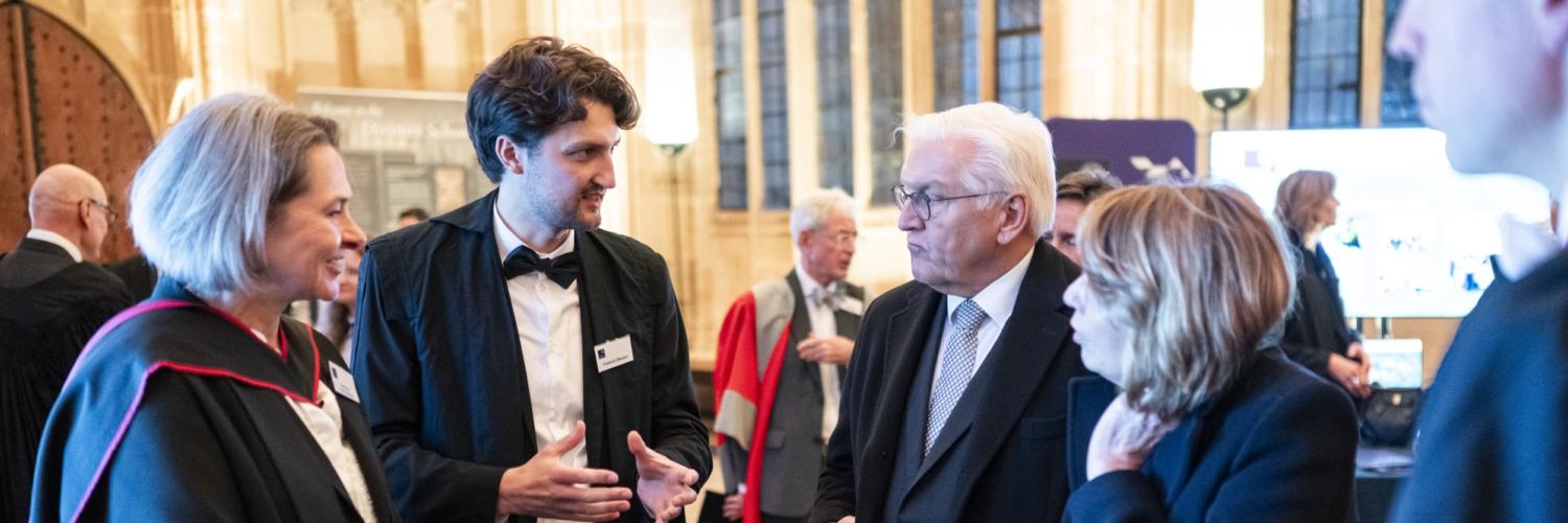 Image of a group of five people in a semi-circle talking