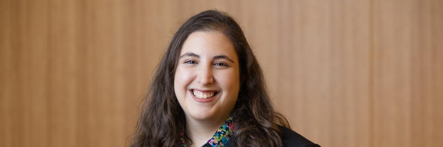 image of a woman wearing a dark jacket smiling at the camera