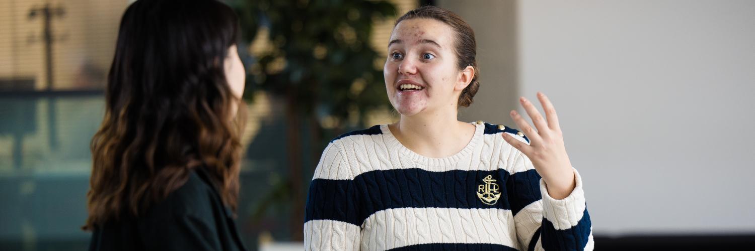 image of two students sat on a bench