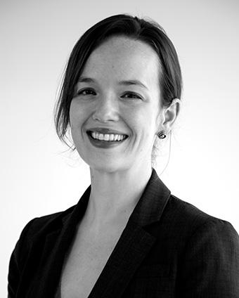 Black and white head and shoulders profile of a woman wearing a dark jacket