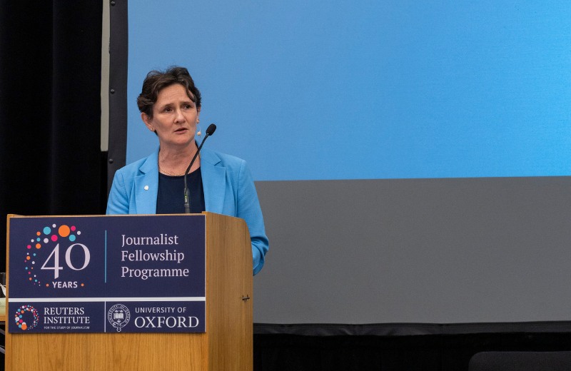 Vice-Chancellor of Oxford University, Professor Irene Tracey standing at a lecturn delivering a speech in front of a blue background