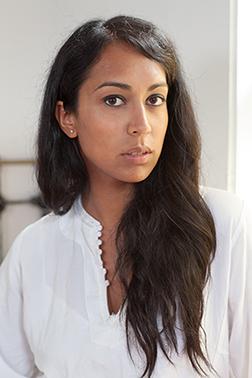 Image of a woman with long hair smiling at the camera