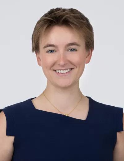 a woman wearing a black top smiling at the camera