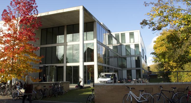 Image of the front of a building with trees to either side