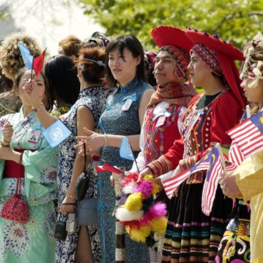 Image of a group of people dressed up holding flags at a parade.
