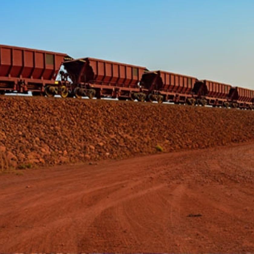 Train trucks passing through a harsh landscape