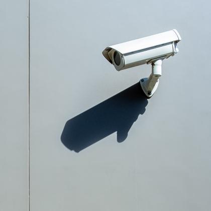 Outdoor wall-mounted surveillance camera with harsh daylight and shadow