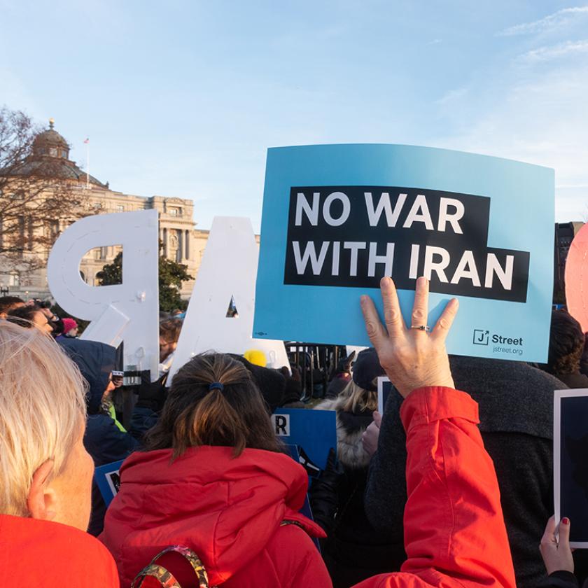 Protest with sign reading 'No War with Iran'