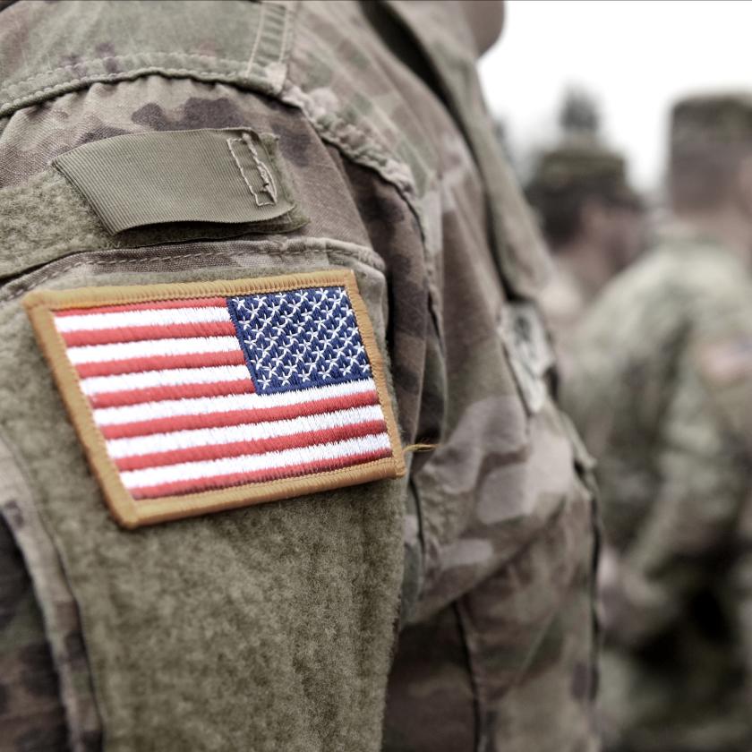 Close up image of a US soldier's arm with a US flag badge on his shoulder