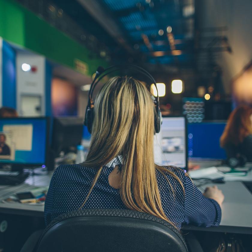 A woman sat in front of a computer screen in an office