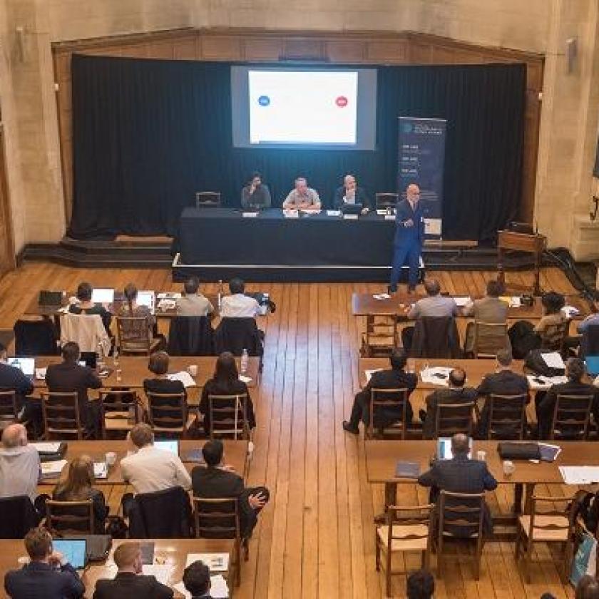 An audience in a room viewed from above and behind