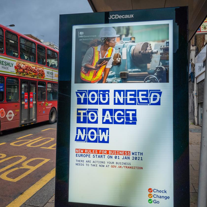 Image of a bus stop with a bus beside it