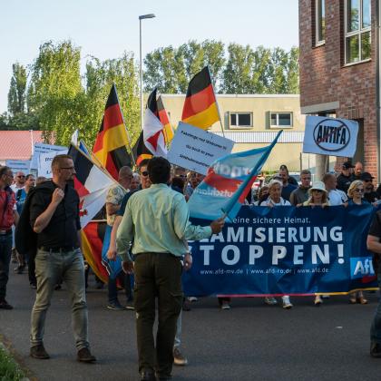 A group of people marching with a banner
