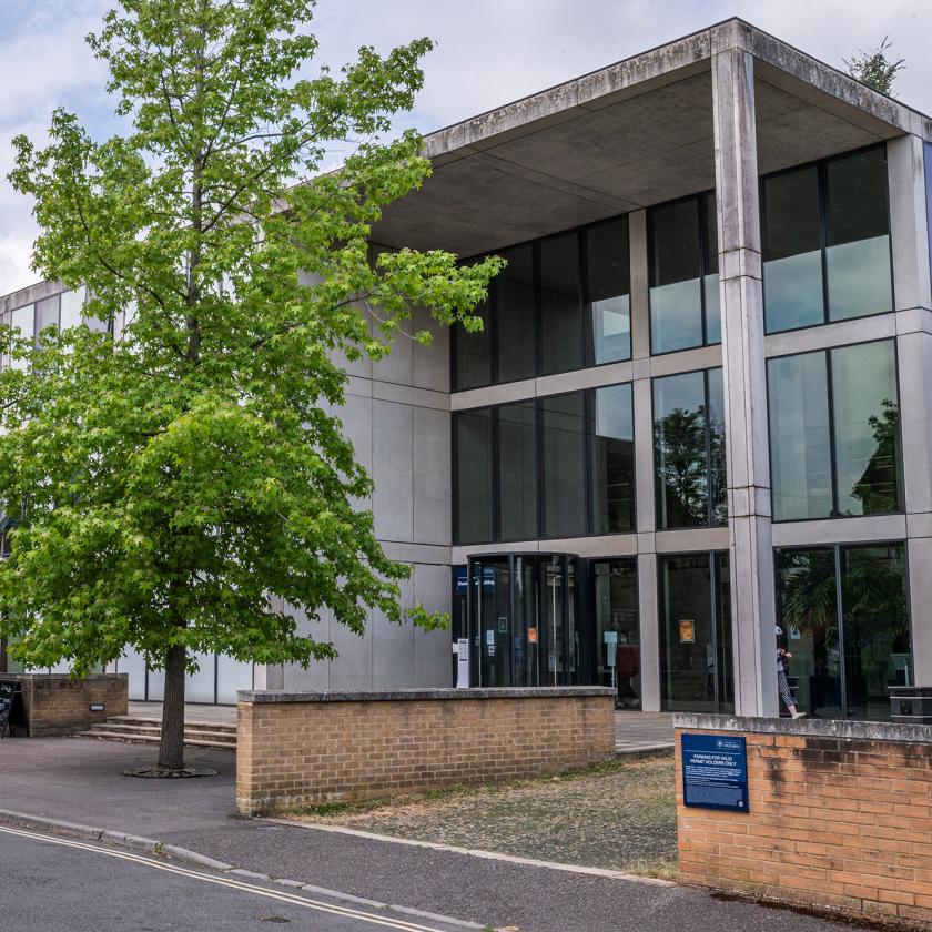 Outdoor shot of Manor Road Building from the road, with tree, sky, building