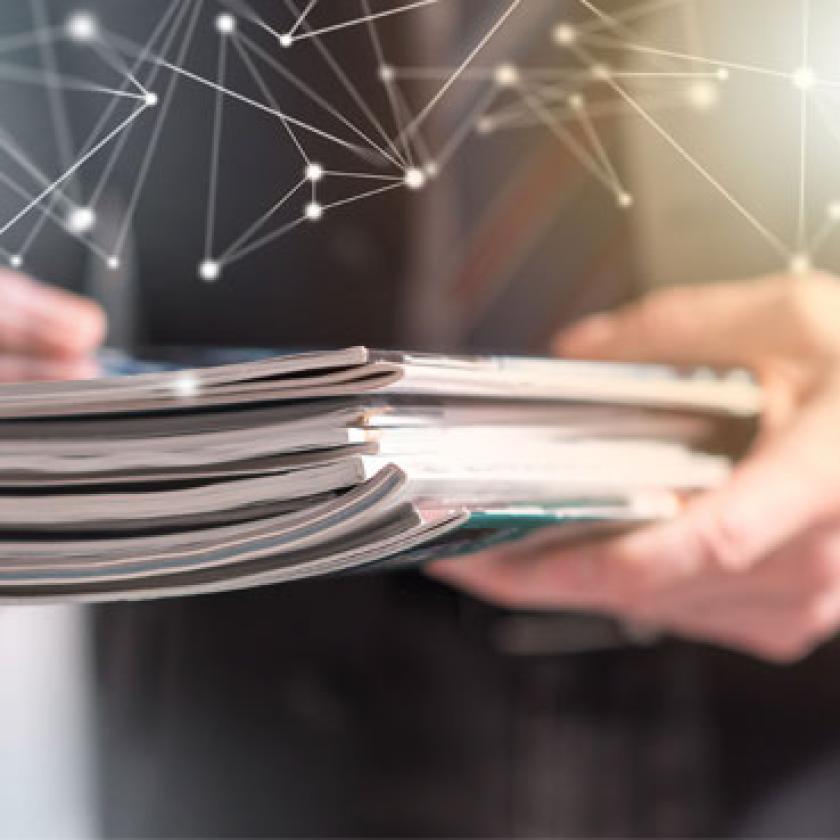 Graphic of a man holding a pile of magazines 