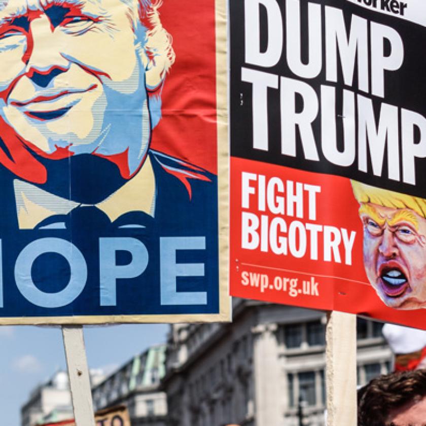 A crowd of people holding signs