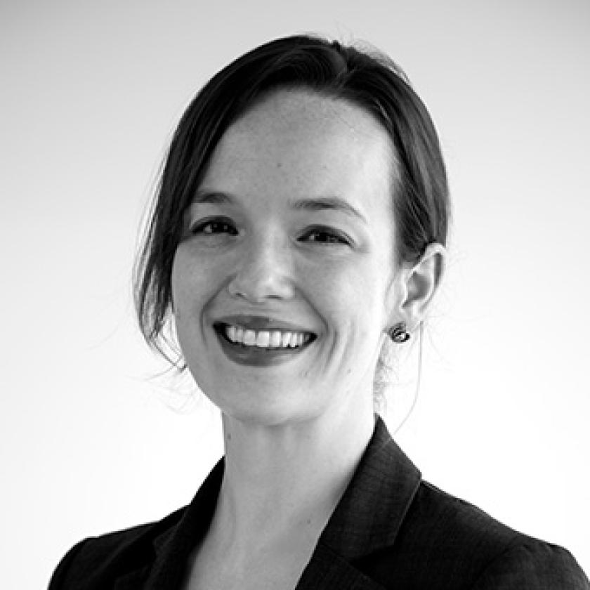 Black and white head and shoulders profile of a woman wearing a dark jacket