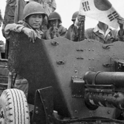 A group of soldiers standing in a military vehicle.