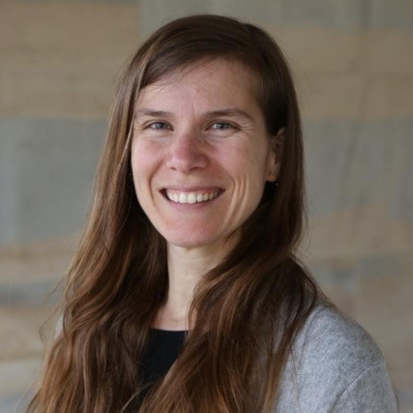 A person with long hair smiling