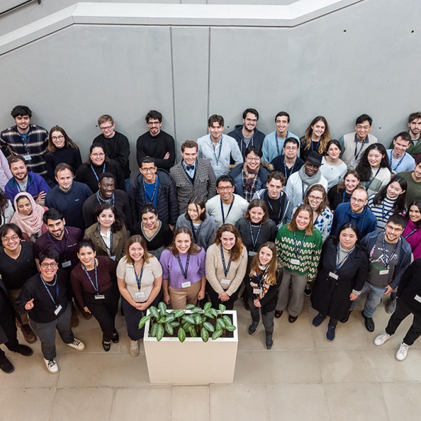 A large group of students photographed from above and looking upwards