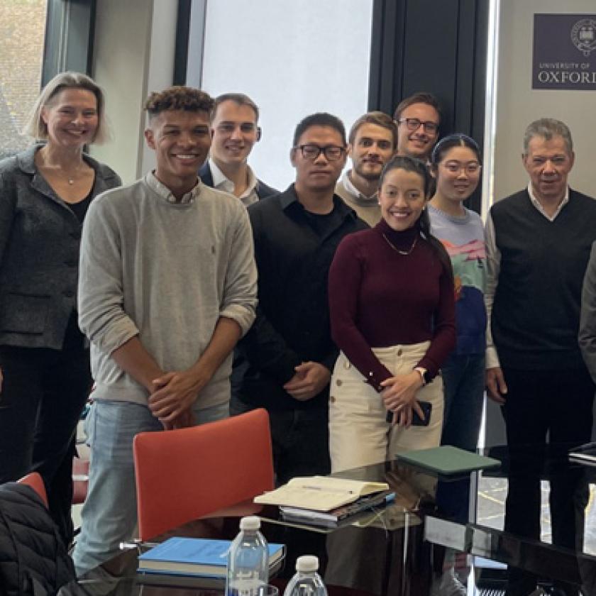 A group of people stood in a room smiling at the camera