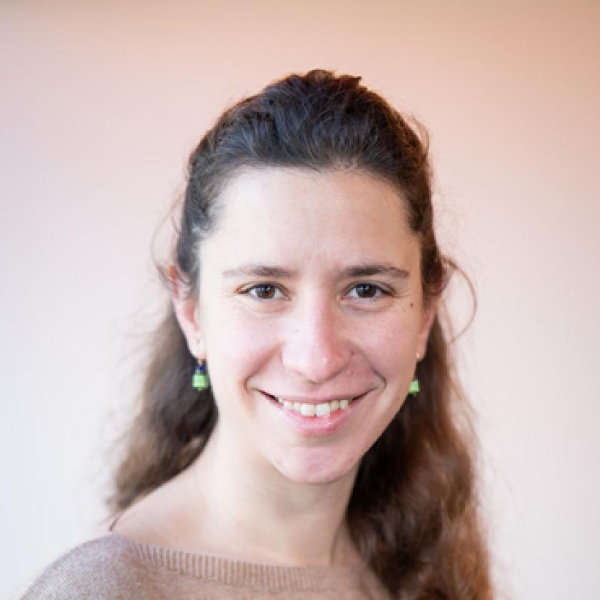 Image of a woman with long hair smiling at camera