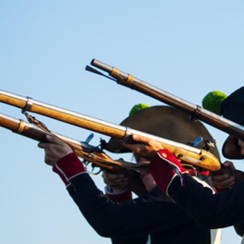 A group of men in uniform holding guns. 