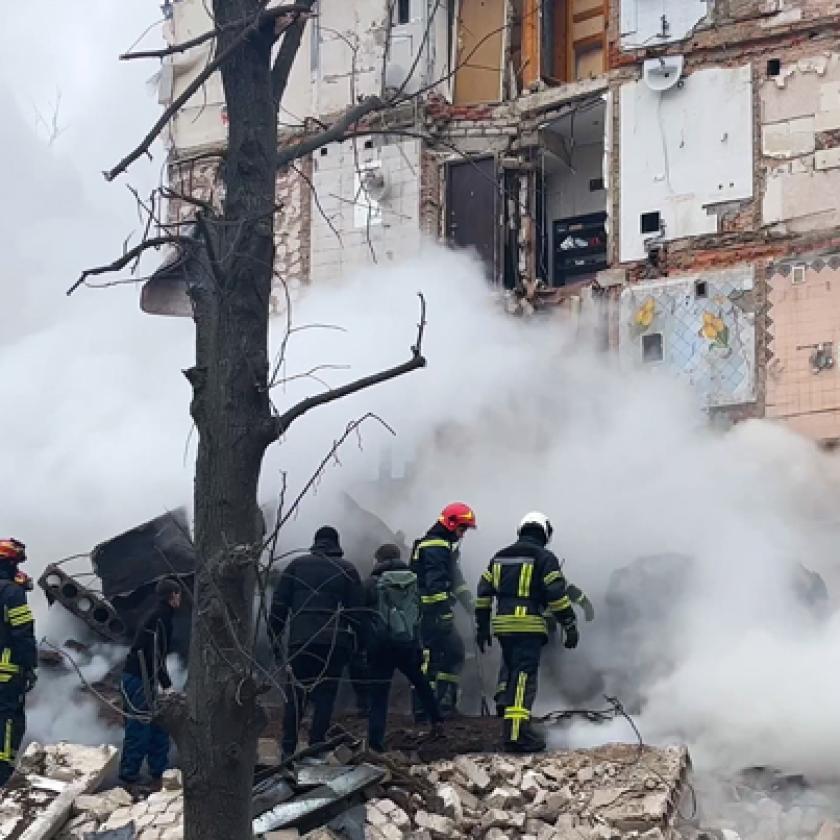 a group of firefighters standing near a building